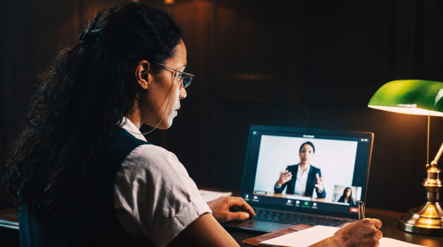 Recruiter conducting a video interview with a candidate on a laptop