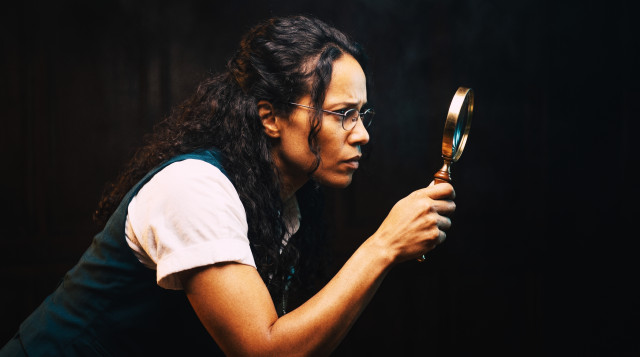 Recruiter examining a candidate detail through a magnifying glass for red flags