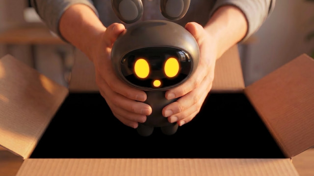 Person placing the VideoApply AI Assistant mascot into a cardboard box
