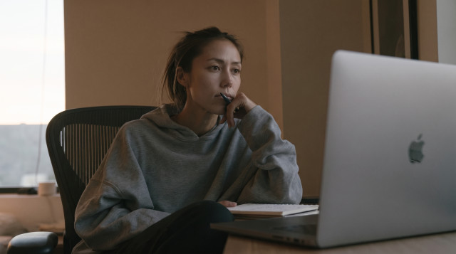 Woman watching a recorded video interview on her laptop